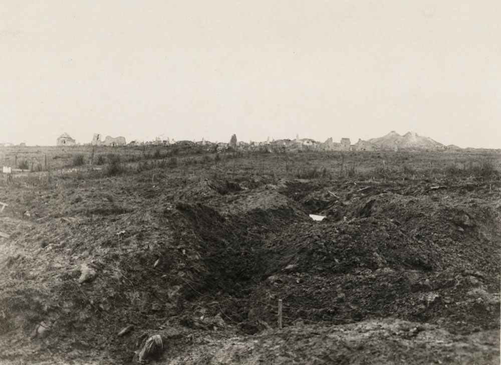The battlefield at Messines with ruins of buildings in the background.